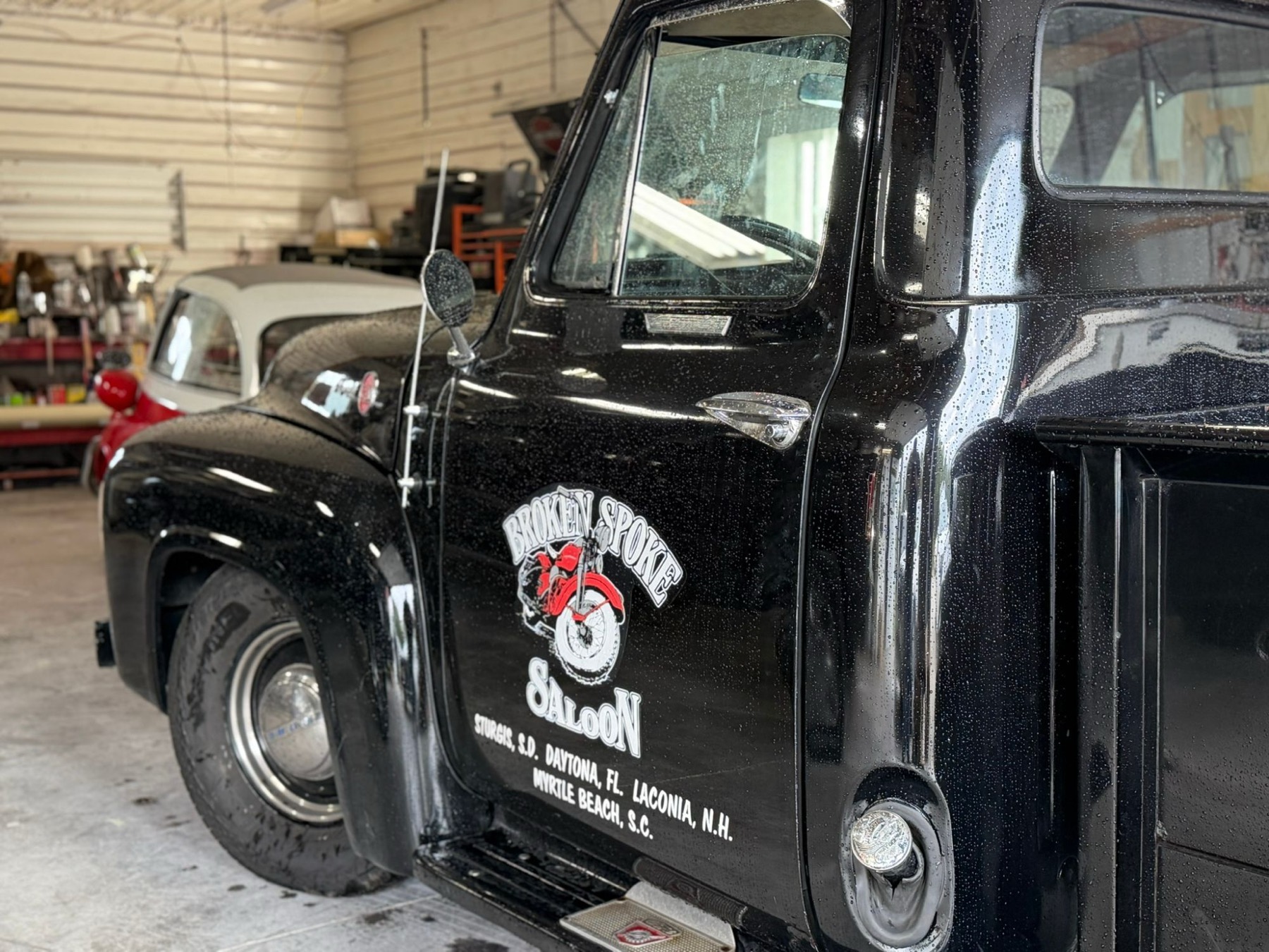 Door of a black Ford pickup with Broken Spoke Saloon lettering